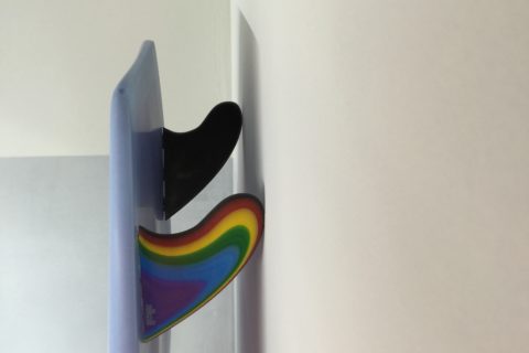 Rainbow coloured surfboard fin